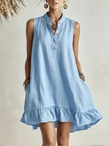 Close-up detail of light blue sleeveless mandarin collar dress with ruffled hem and pockets