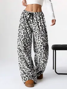 Detailed view of trendy leopard print wide-leg trousers featuring a drawstring waist design.