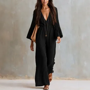 Elegant bohemian black long-sleeve jumpsuit featuring a deep V-neck and elastic waist