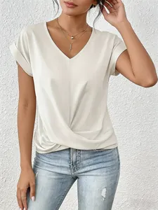 Detail view of an elegant cream V-neck short sleeve top with twist front design.