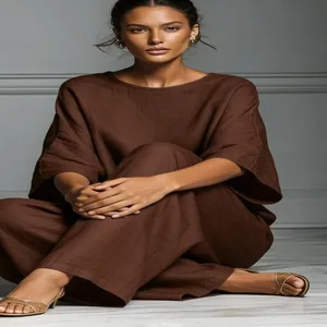 Detailed macro view of elegant brown linen two-piece set with flare sleeves worn by model