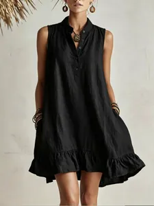 Detailed view of a black sleeveless linen-texture dress with a ruffle hem and pockets.