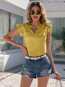 Detailed shot of yellow satin V-neck shirt featuring ruffled sleeves on a model