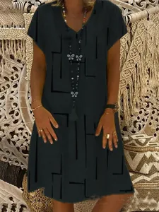 Close-up detail of women's black V-neck short sleeve dress with butterfly print