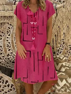 Detailed shot of woman wearing a pink V-neck summer dress with black geometric line print