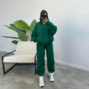 Full view of women's forest green oversized fleece tracksuit with zip-up hoodie and pants
