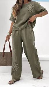 Detailed view of women's olive green linen casual two-piece set with flower embroidery