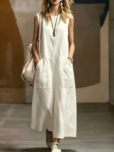 Close-up of a minimalist white sleeveless maxi dress featuring functional side pockets