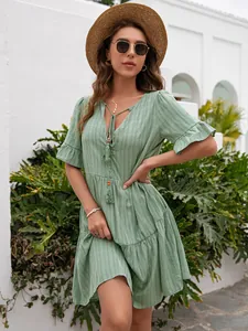Elegant sage green summer midi dress featuring a V-neck and tiered ruffle sleeves