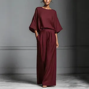 Elegant burgundy linen two-piece set featuring bell sleeve top and wide leg trousers