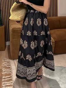Bohemian high-waist long A-line skirt with golden floral print in lifestyle setting