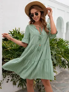 Bohemian green V-neck dress with tassel detail and ruffles for summer outings