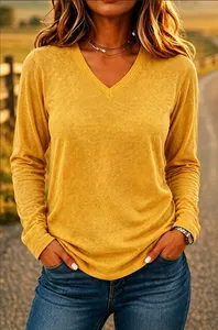 Close-up of mustard yellow V-neck long-sleeved T-shirt with soft knit texture