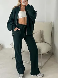 Detailed view of women's dark green oversized zip-up hoodie and matching wide-leg pants set