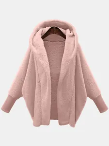 Close-up of a women's oversized fuzzy teddy fleece hooded jacket in dusty pink