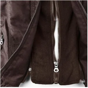Detailed view of heavy-duty metal zippers and dark brown faux leather texture on jacket