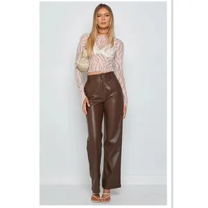 High-waist brown PU leather wide-leg pants for women featuring a smooth matte finish