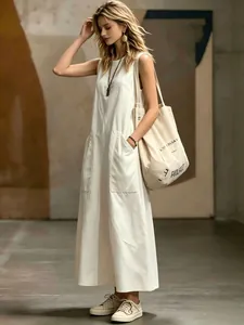 Elegant sleeveless white maxi dress with pockets for a chic minimalist summer look
