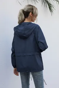 Back view showing details of women's navy blue lightweight hooded windbreaker jacket
