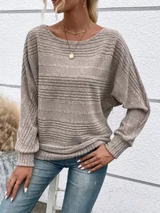Detailed view of women's casual beige ribbed long-sleeve top with batwing sleeves