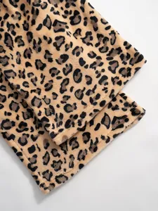 Detail view of the soft hem on these leopard print plush wide-leg lounge trousers