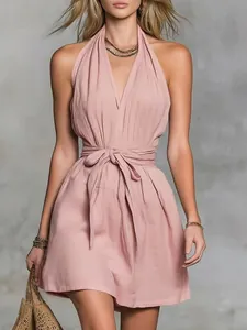 Close-up view of a pink halter neck V-neck vacation dress with an adjustable waist tie