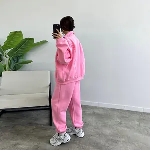 Back view of a women's pink oversized fleece tracksuit set with zip jacket and joggers