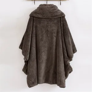 Vista posteriore dettagliata di un poncho oversize in peluche marrone in morbido pile