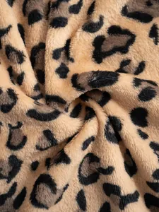 Macro detail shot of soft leopard print plush fabric showing rich texture and fluffy fibers