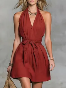 Close-up view of a deep red halter V-neck summer dress featuring a waist tie detail