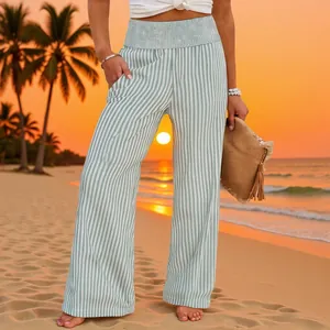 Detail view of vertical striped wide-leg pants with a smocked high waist for beach