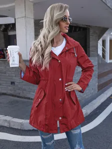 Elegant women's hooded mid-length red raincoat worn by a model in an urban setting.