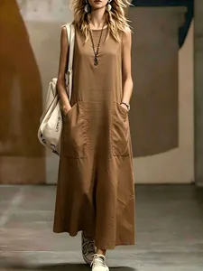 Close-up of sleeveless brown maxi dress with functional front pockets.