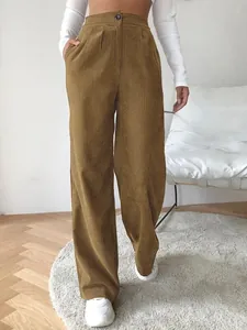 Detail view of high-waisted brown corduroy wide-leg trousers showing texture and fit