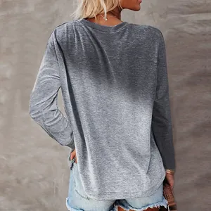Macro view of gray ombre gradient on long sleeve casual t-shirt shown from back.