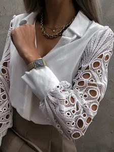 Close-up detail of white shirt with intricate hollow-out lace patchwork sleeves
