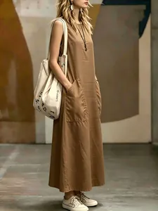 Elegant sleeveless tan maxi dress with large front pockets and minimalist style