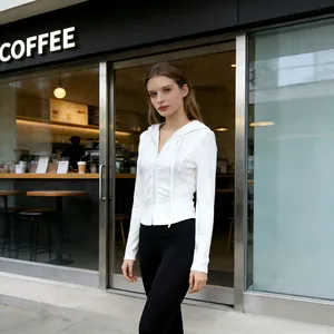 Slim-fit women's white ribbed zip-up hooded sweatshirt worn in street setting