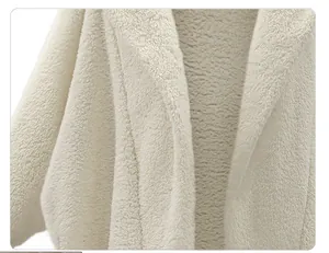 Close-up detail of soft white fuzzy hooded jacket showing plush fleece texture