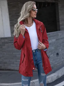 Model wearing red mid-length hooded raincoat with zipper and pockets in urban setting
