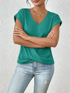 Detail view of an emerald green V-neck T-shirt with elegant twist front hem design.