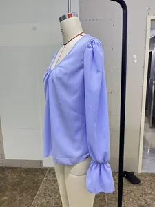 Side view of lavender V-neck long-sleeve blouse with elegant pleated ruffled cuffs.