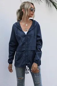 Detail of a navy blue women's lightweight hooded zipper jacket for outdoor hiking and travel.