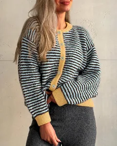 Close-up of a blue and brown striped knitted cardigan featuring yellow ribbed trim and buttons.
