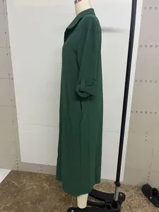 Detailed side profile of a loose retro dark green long-sleeved maxi shirt dress for women