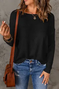 Close-up detail of a casual black long-sleeve knitted sweater with fine texture