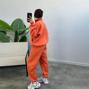 Cozy orange fleece-lined two-piece tracksuit set with zip-up sweatshirt and joggers.