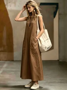 Sophisticated brown sleeveless maxi dress featuring dual pockets and a minimalist design