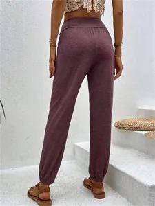 Detailed back view of women's purple jogger pants showing high waist and elastic cuffs