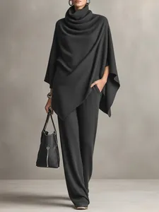 Elegant dark grey knit two-piece set with turtleneck poncho and wide-leg trousers